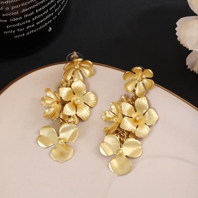 Elegant and Chic: Intricate Floral Design Earrings with Golden Petals and Long Tassels