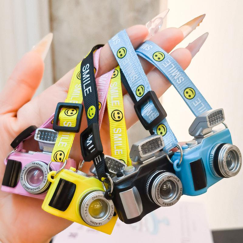 Mini Smiling Doll Camera Pendant with Luminous Ribbon and Plush