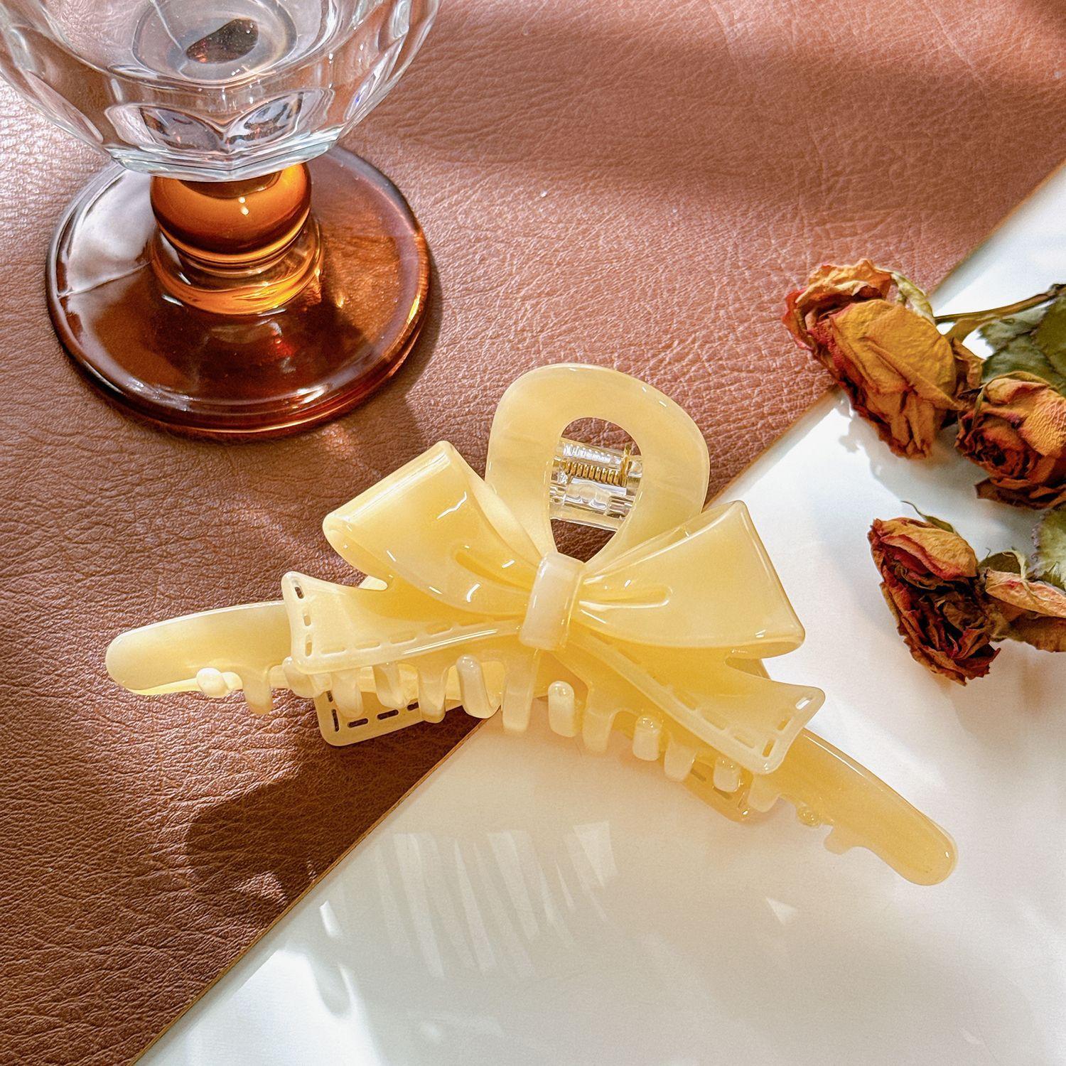 

Hair Womens Fashionable Claw Clip In Sophisticated Acetate With Charming Bow Detail Goose Yellow