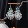 Bohemian Ethnic Miao Silver Tassel Earrings with Butterfly, Peacock, and Flower Design for Women – Long Dangle Jewelry for Travel Photos.