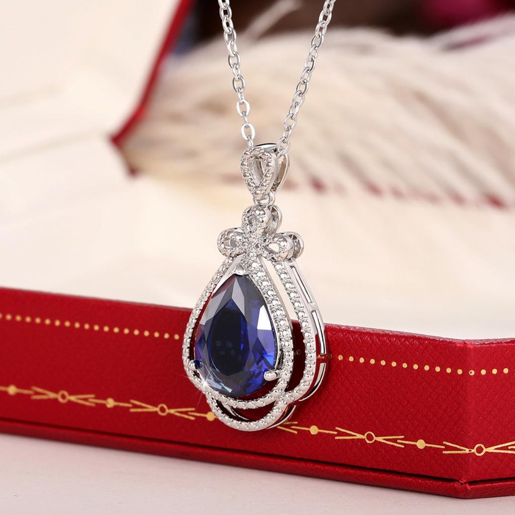 Deep Blue Teardrop Pendant Necklace with Double Sparkling Halo and Bow Accent Elegant Royal Inspired Jewelry for Women