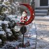Retro Style Garden Art 31 Inch Solar-Powered Christmas Stake Light, Santa Claus on A Moon LED Pathway Auto Solar Powered Lamp Light with Snowflake
