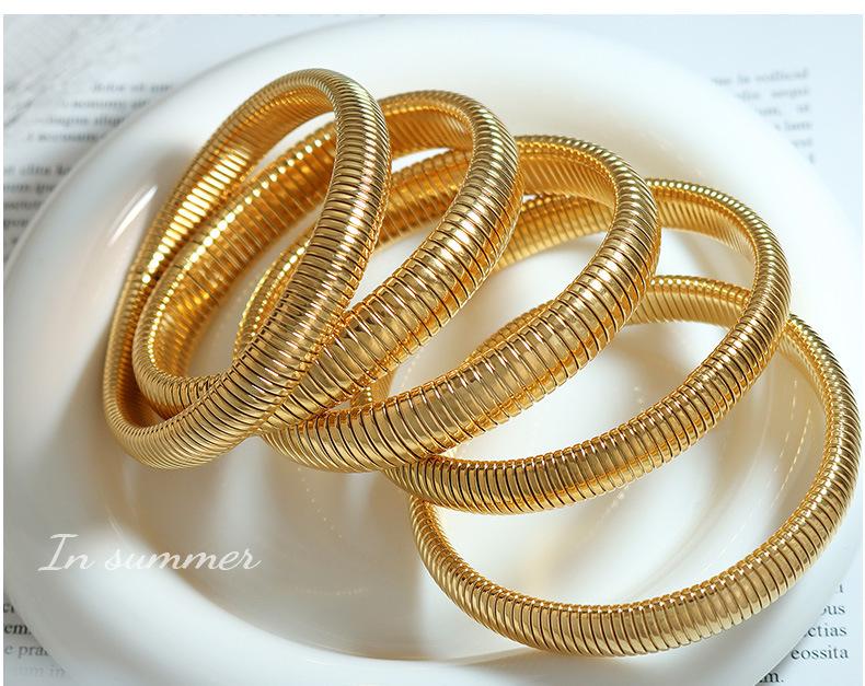 Retro Elastic Wide & Narrow Band Bracelet for Women - Gold-Plated Titanium Steel Fashion Bangle with French Personality Niche Design.