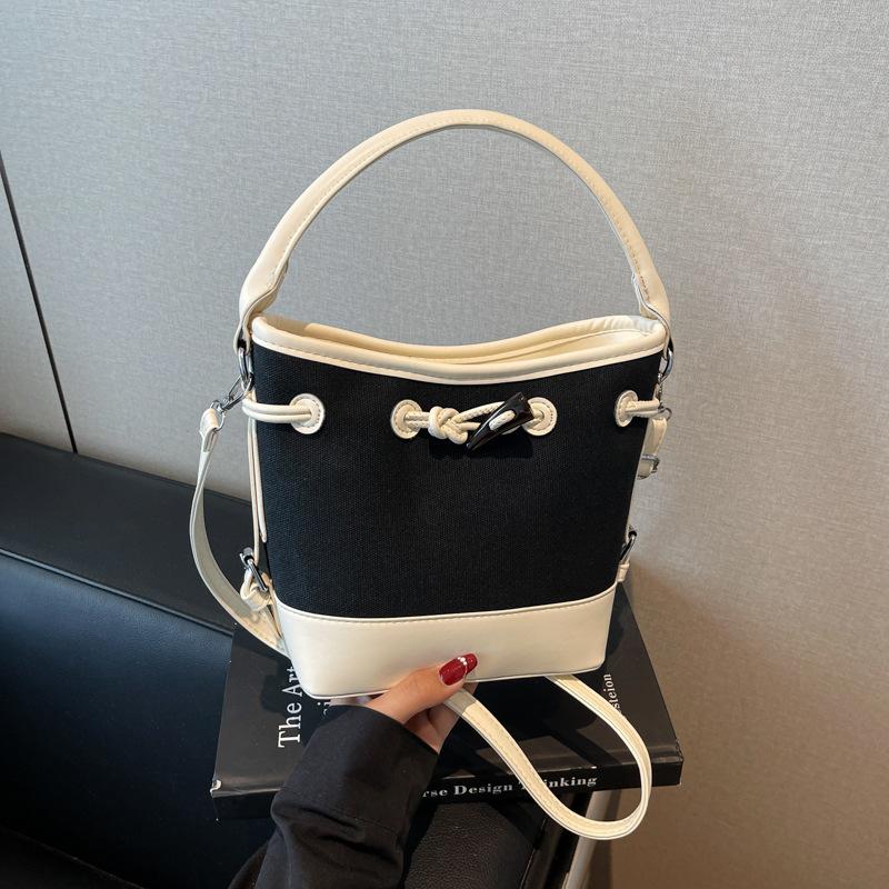 

Niche canvas splicing bucket bag women s new portable commuter bag fashion shoulder messenger bag tide білий