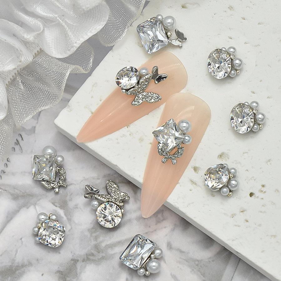 Elegant Nail Art: Pearl & Butterfly Inlaid Pigeon Egg with Zirconia and Rhinestones