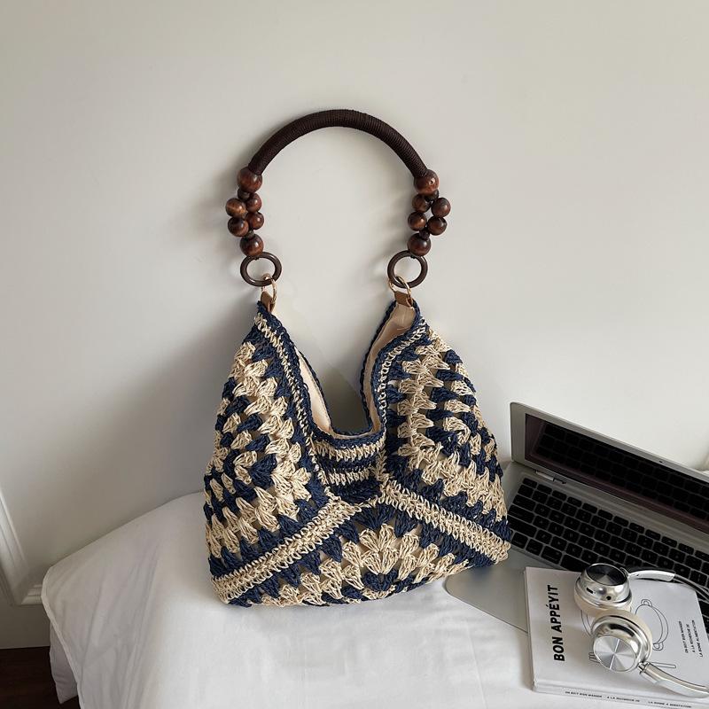 Sommer beliebte gewebte Tasche Damen neue Mode hohl tragbare Umhängetasche Strandurlaub Tragetasche