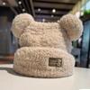 Autumn and winter thickened soft waxy warm cold ear protection cold hat Korean version of metal cute bear plush knitted versatile model