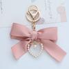 Elegant Pearl Strand Bow Keychain with Heart Charm, Octagonal Shape, Floating Fun-Themed Accessory, with Split Ring Closure for Handbags and Car Keys
