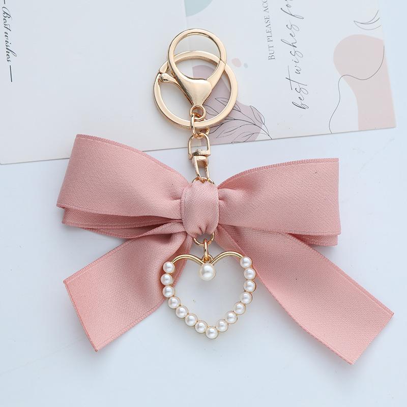 Elegant Pearl Strand Bow Keychain with Heart Charm, Octagonal Shape, Floating Fun-Themed Accessory, with Split Ring Closure for Handbags and Car Keys