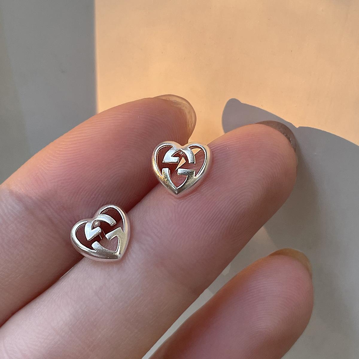 

Screw mouth love hollow earbone nails ins niche design women s high-end studs 925 sterling silver fashion earrings 925 Silver