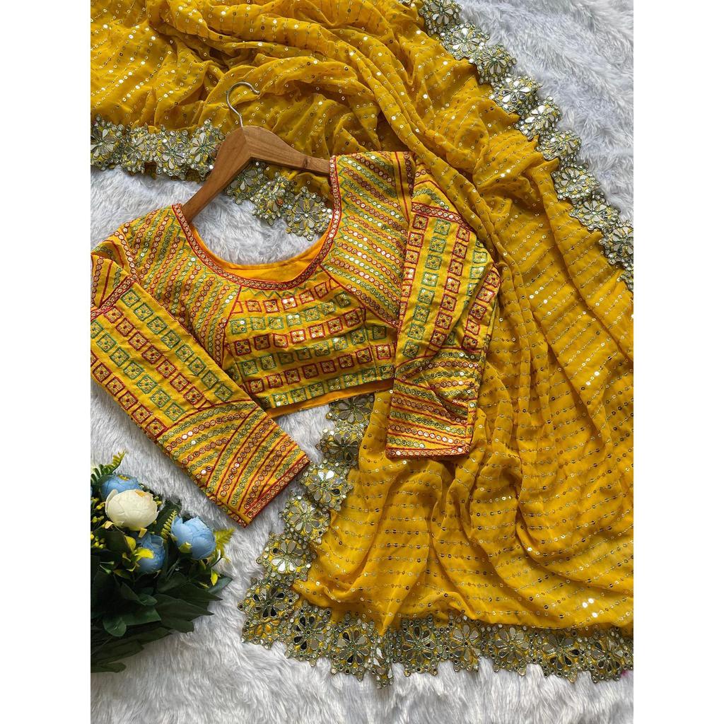 Lanzando un hermoso sari de fiesta de color amarillo con trabajo de espejo de diseño