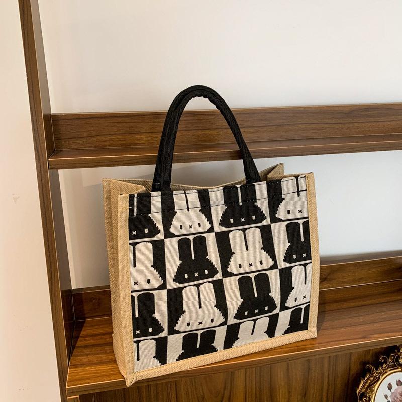 Handtaschen mit großem Fassungsvermögen sind dieses Jahr beliebt, und Damen 2025 neue trendige Mode und niedliche Schultertaschen mit Kaninchenaufdruck.