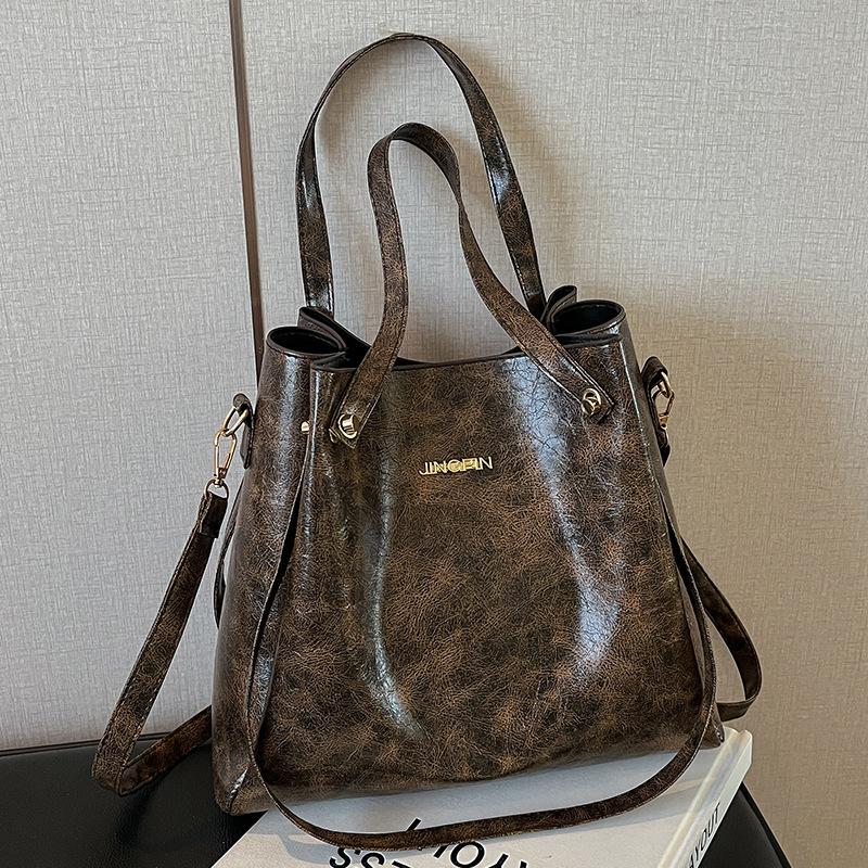 Beliebte Taschen für Frauen Große Kapazität Neue Retro-Mode Breitbandige Einzel-Schulter Crossbody-Tasche Hand-Eimer-Tasche