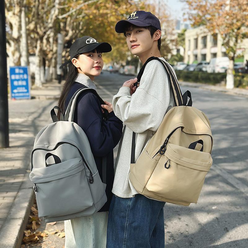Casual large-capacity backpack fashionable outdoor lightweight junior high school students solid color simple schoolbag Korean version travel backpack