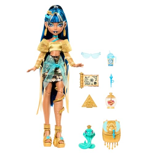 Enthält Monster High Cleo de Nile Puppe, goldene Bluse und Stufenrock, Haustierkobra Hiset und Zubehör wie Rucksack, Snacks, Schriftrolle und mehr.