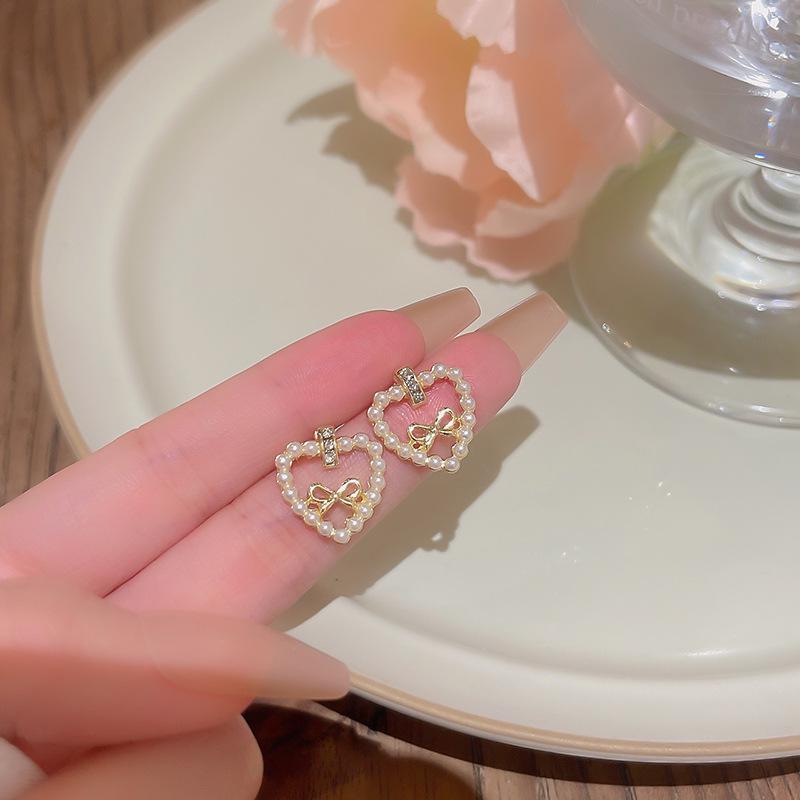 

High-End S925 Silver Pearl Bow Earrings with Hollow Heart Design