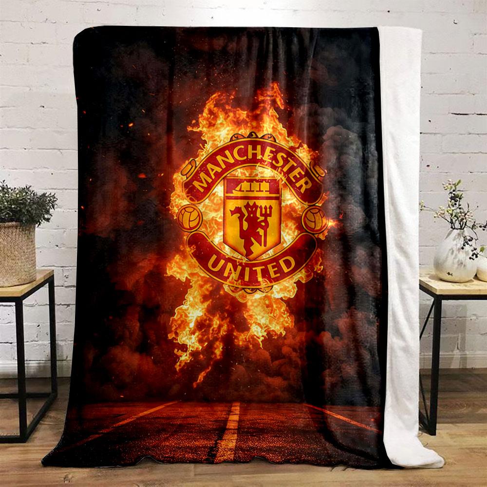 A Fiery Manchester United Logo Emerges Against Smoke and a Dark Background. for All Seasons Blanket Lunch Break Throw Gift