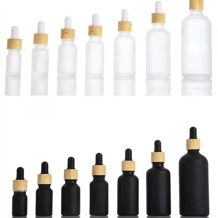 Mattschwarze Frosted Glass Flasche für ätherische Öle mit Holzmaserungsring und Tropfer/Sprühaufsatz