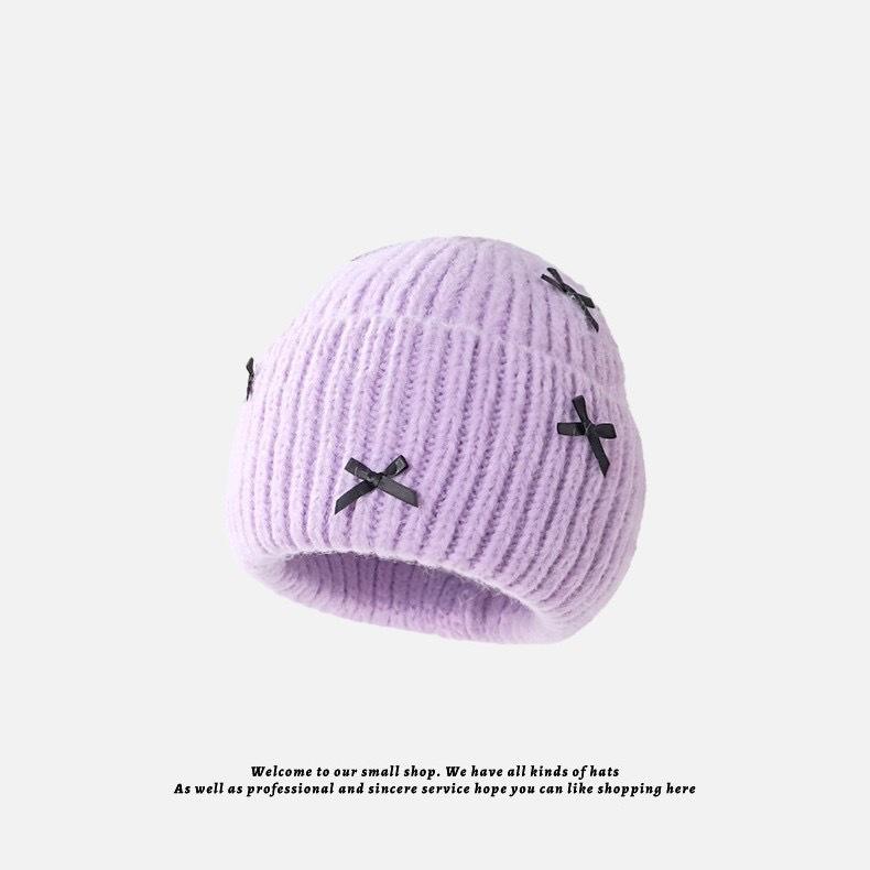 

Осінньо-зимова мила шапка з вовни в язки з бантом для жінок фіолетовий