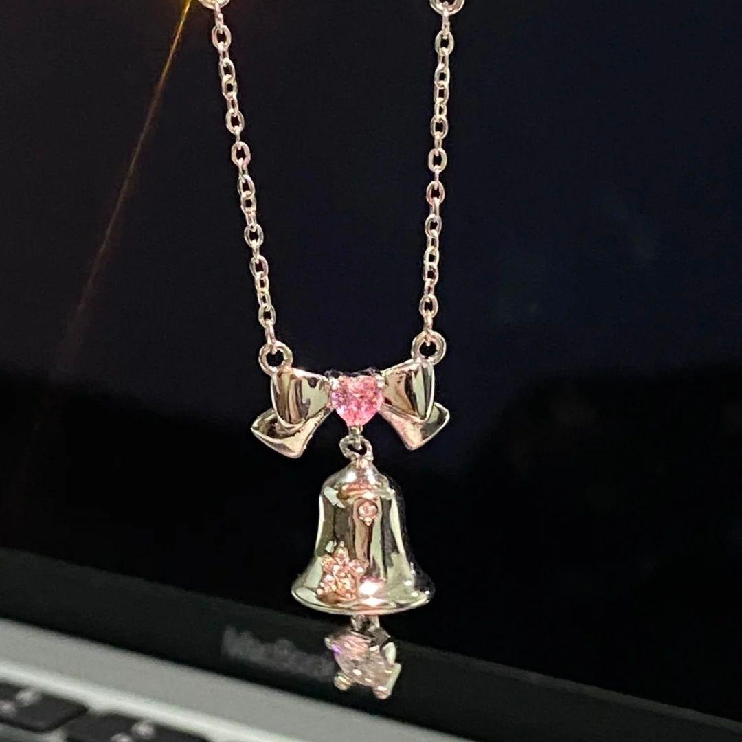 

A single-piece silver-pink bow and bell necklace. A sophisticated and elegant Christmas bell jewelry piece, perfect as a Christm pink&Other