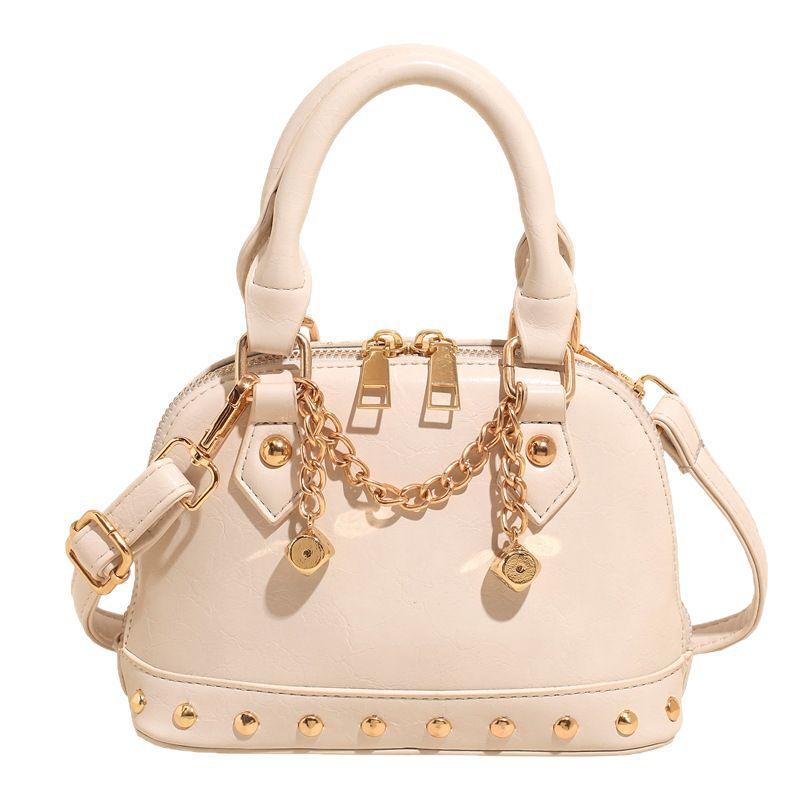 2025 new niche design high-end champagne rivet portable shell bag women's fashionable foreign style shoulder messenger bag