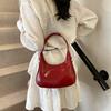 Fashion birth girl small bag 2025 new patent leather design sense portable crescent bag hand carry niche unique underarm bag