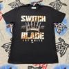 Switchblade Jay White Unisexe XL T-shirt Aew