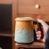 Handcrafted Ceramic Tea Mug with Infuser and Lid – 400ml Heat-Resistant Cup with Wooden Handle, Artistic Mountain Design
