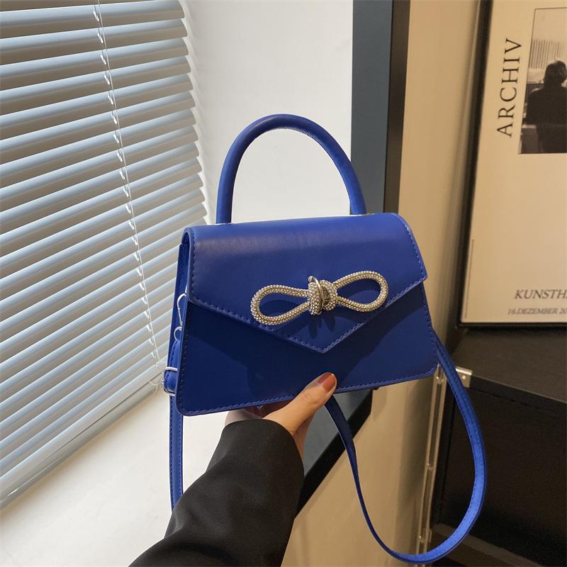 Simple and popular versatile solid color bow sewing line women's bag fashionable oblique span shoulder handbag