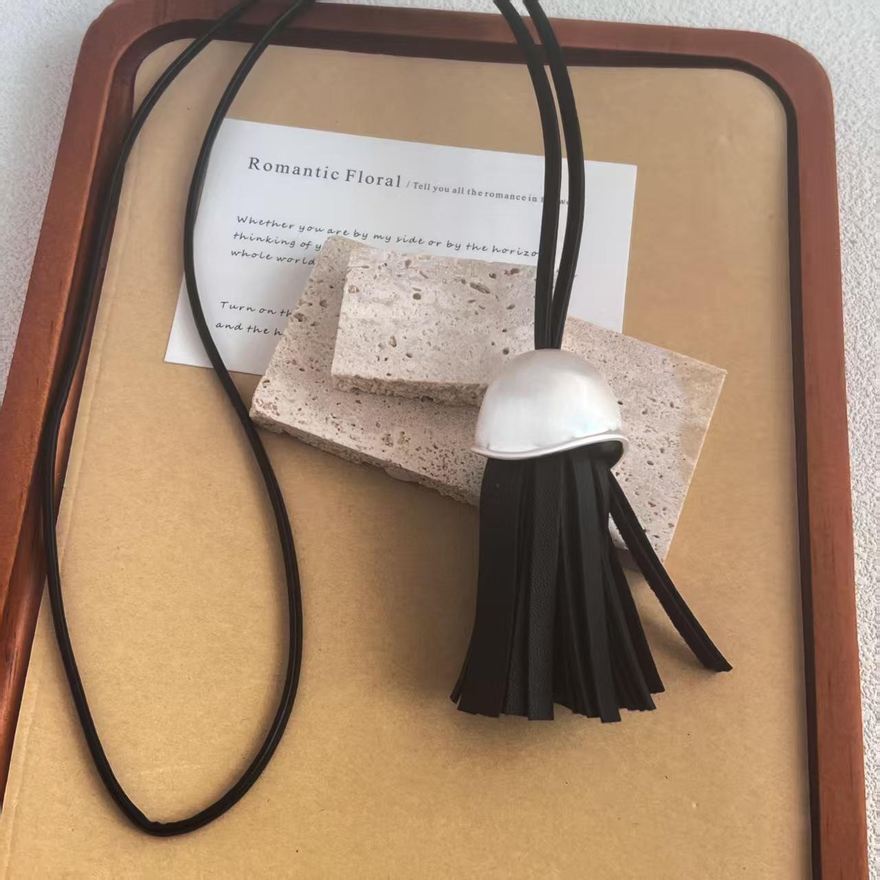 

Korean Style Leather Tassel Necklace: Simple, Fashionable, Light Luxury Pendant for Versatile Sweater Chains, 25 New Designs