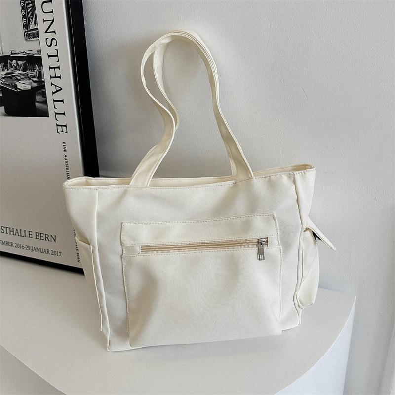 

Корейская версия нишевого дизайна простая холщовая однотонная сумка женская сумка 2024 зимняя новая сумка большой вместимости через плечо подмышку белый