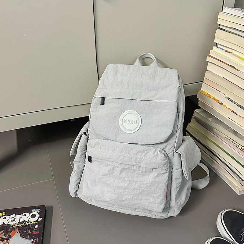 

New Japanese outdoor lightweight fashion schoolbag backpack small backpack women s simple and versatile new travel schoolbag women світло-сірого кольору