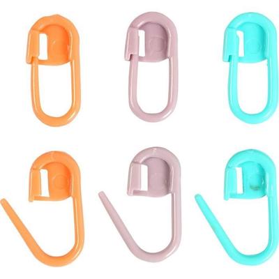 Small Plastic Tool with Shape and Function Like a Safety Pin. It Is Used When Working the Hook and the