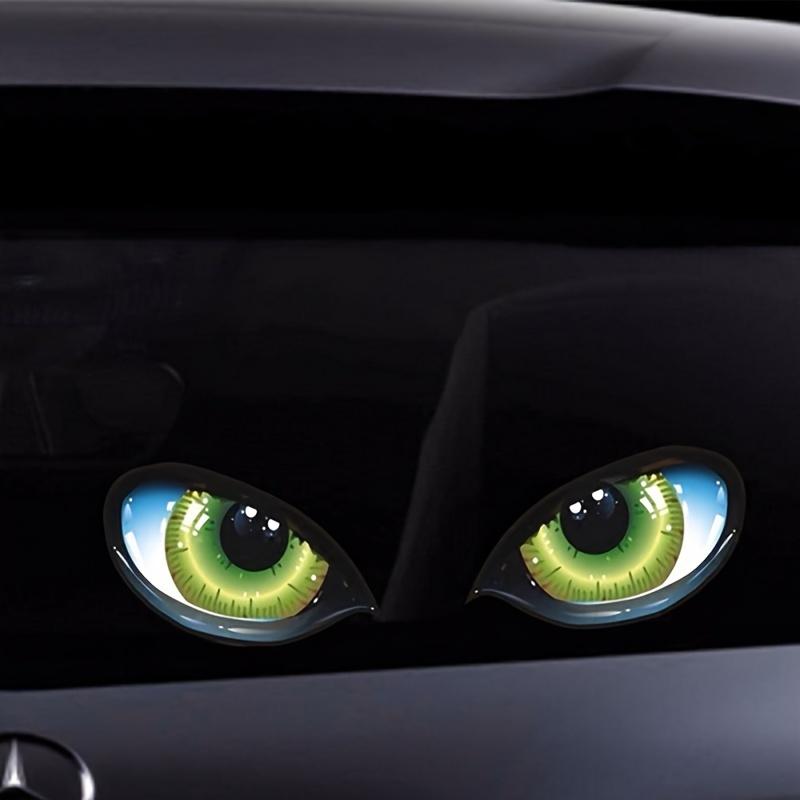 Two Imaginative Vehicle Decals Featuring Bright Three-Dimensional Green Cat-Like Eyes That Seem To Be Watching