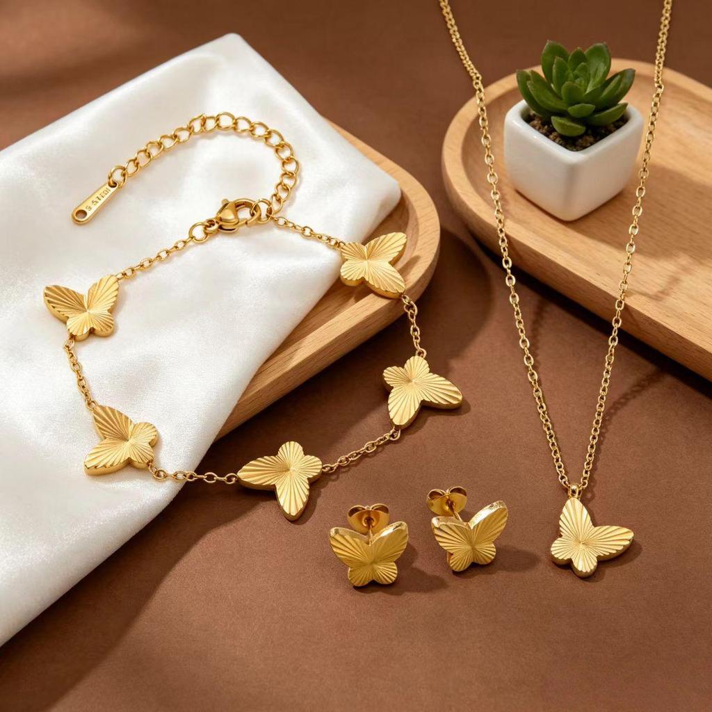 Gold Plated Titanium Steel Jewelry Set with Butterfly Carving: Necklace, Bracelet, and Earrings.