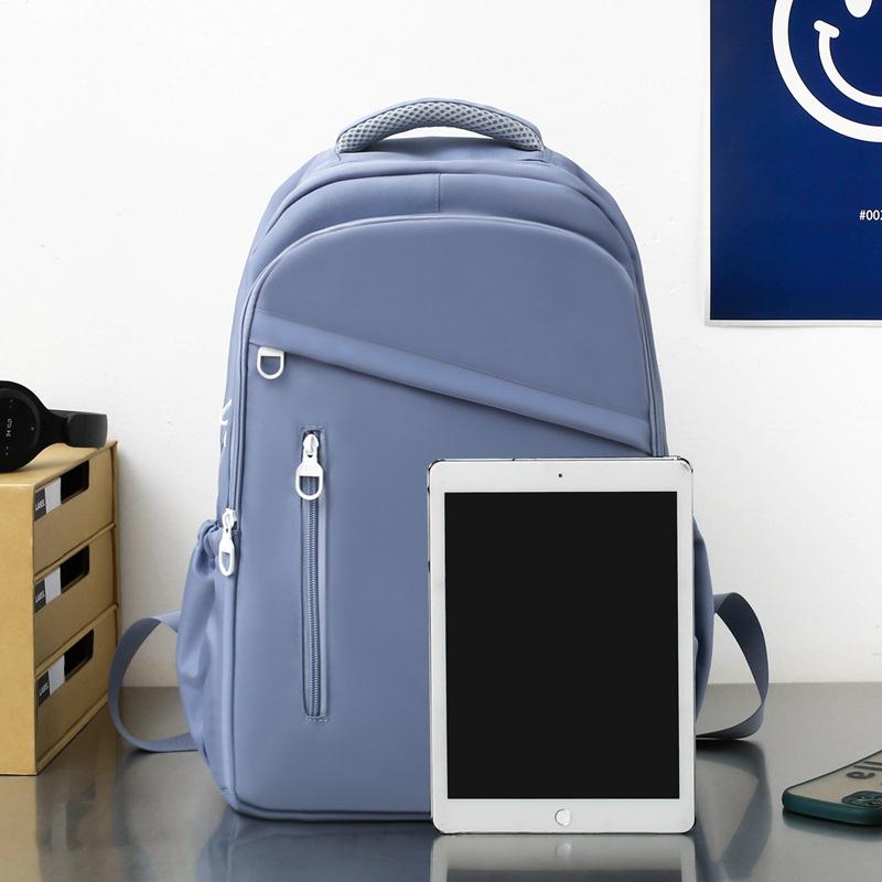 New student schoolbag, girls' large-capacity weight reduction, light solid color simple junior high school backpack