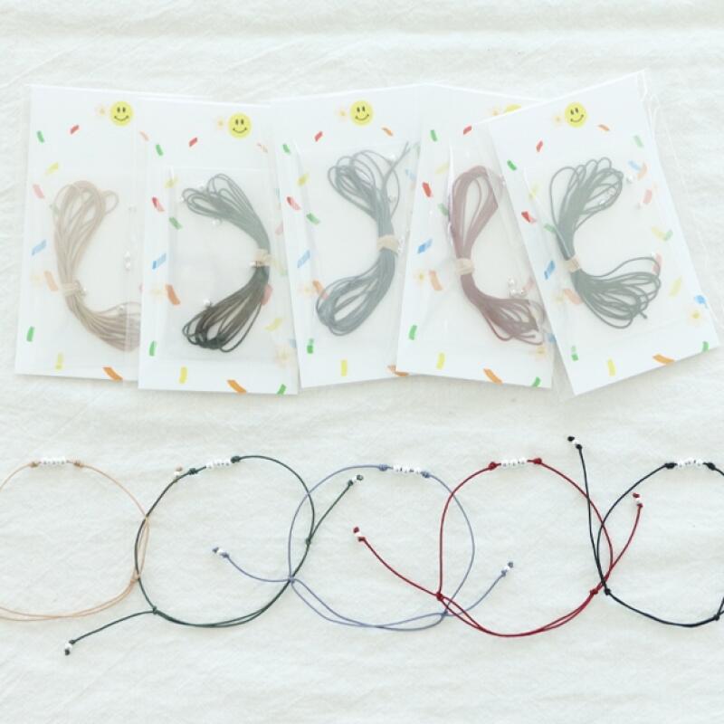 12-piece DIY kit for making a wish bracelet with a skein of macrame.