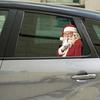 3D Simulation of A Funny Christmas Santa Claus on The Glass Window, with Decorative Stickers for Beautifying The Window.