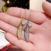 Vintage Feather Pendant Necklace with Sparkling Round Stone Accent Elegant Nature Inspired Jewelry for Women