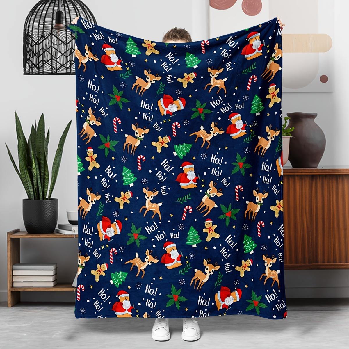 

1 Christmas-themed blanket decorated with Santa Claus reindeer gingerbread men and candy cane patterns in navy blue 30x40in