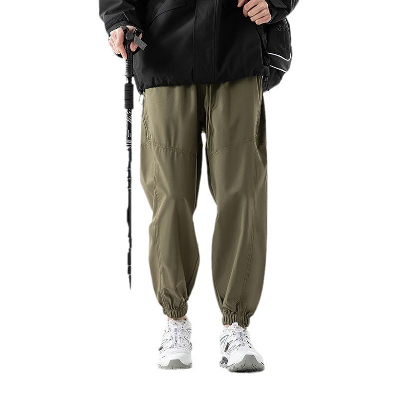 Functional waterproof charging pants spring and autumn loose tied feet casual breathable sports pants outdoor mountaineering trousers
