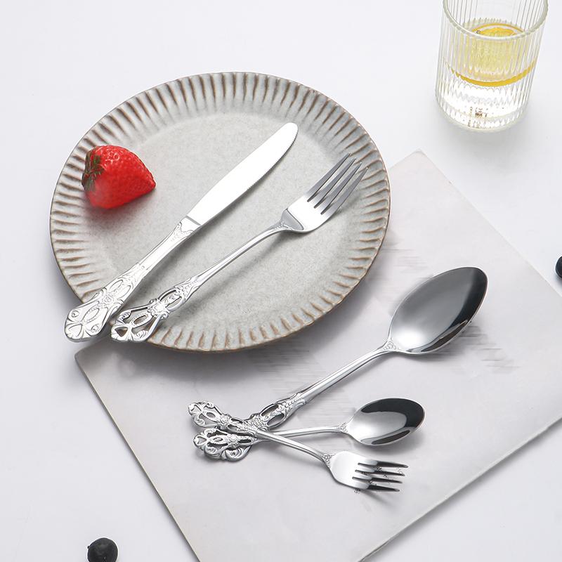 40pcs Elegant Silver Cutlery Set Features Stainless Steel Openwork Handles and Includes Forks, Spoons, and Knives. Perfect for W
