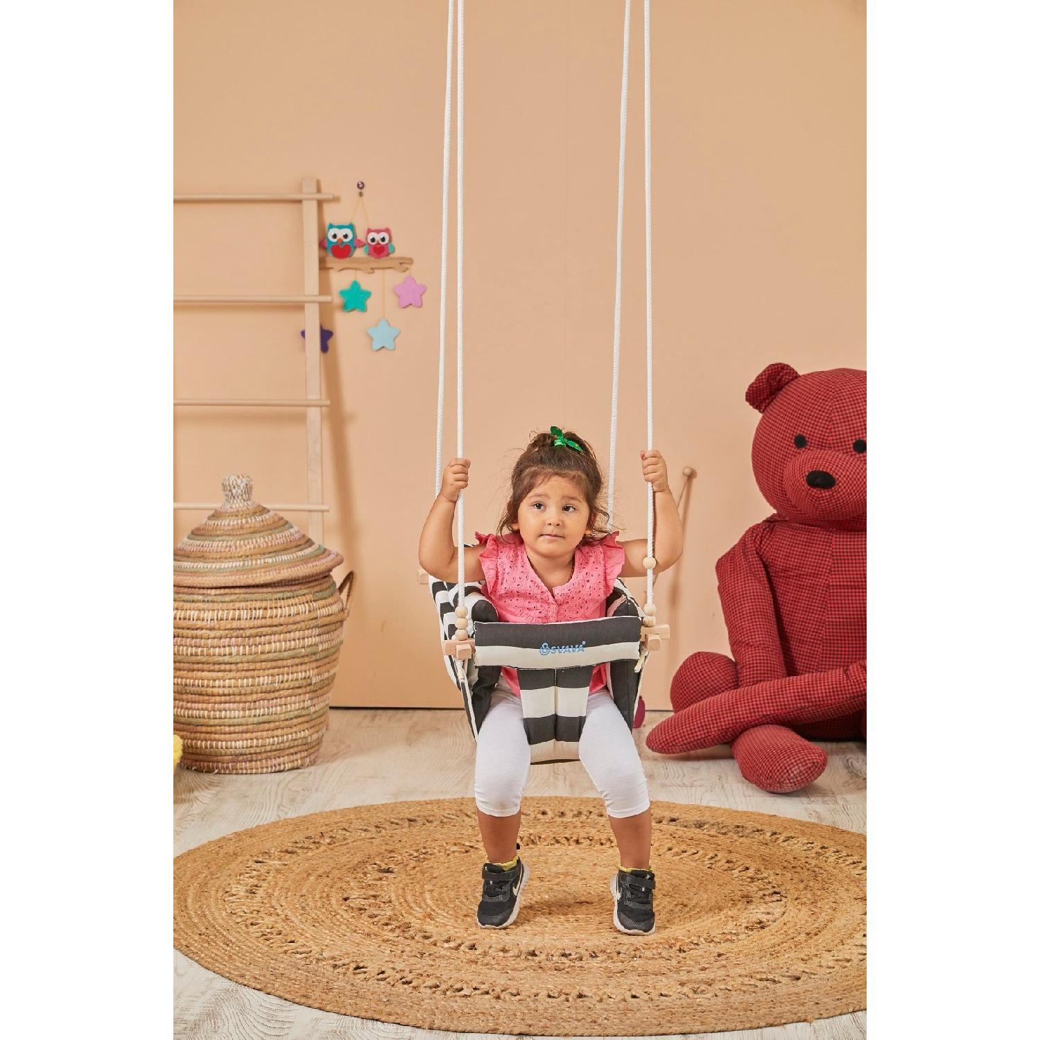 

Plus Wooden Baby Swing, The Child Hanging On The Ceiling Is Black