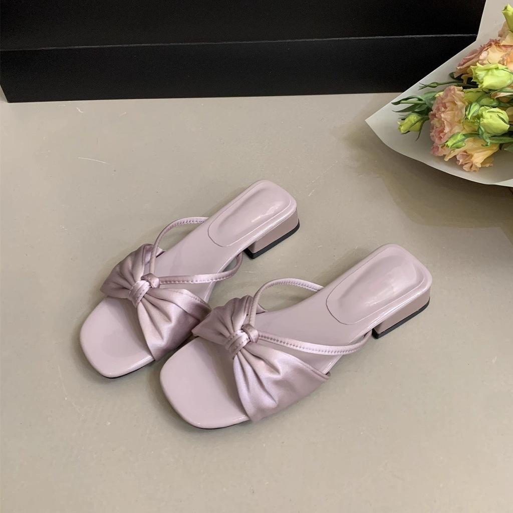 French beautiful slippers women's summer wear 2025 new fairy bow one-word drag thick heel with skirt beach sandals