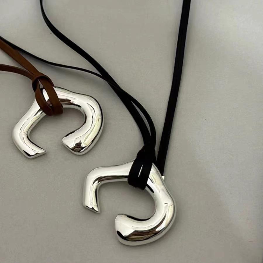 Brown Leather Cord Necklace with Silver Abstract Human Body Pendant – Autumn/Winter Light Luxury Clavicle Chain
