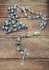 Catholic necklace with deep blue crystal crown beads, rosary, sacred earth medal and cross.