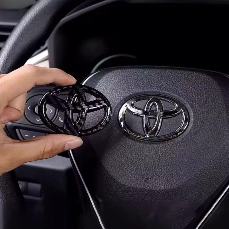 65X47MM Car Steering Wheel Center Emblem Logo Sticker For Toyota Corolla Yaris Aygo Prius RAV4 Crown CHR Camry Auris Verso