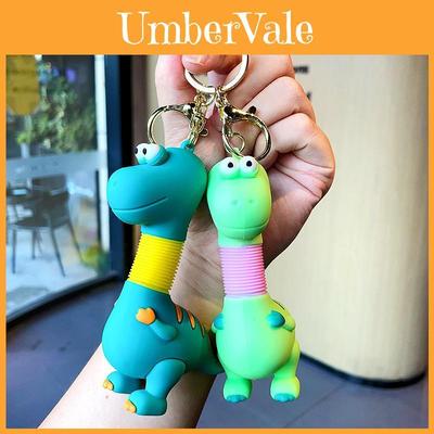 Niedlicher, einziehbarer Dinosaurier-Schlüsselanhänger im süßen Cartoon-Design für Kinder und Erwachsene.