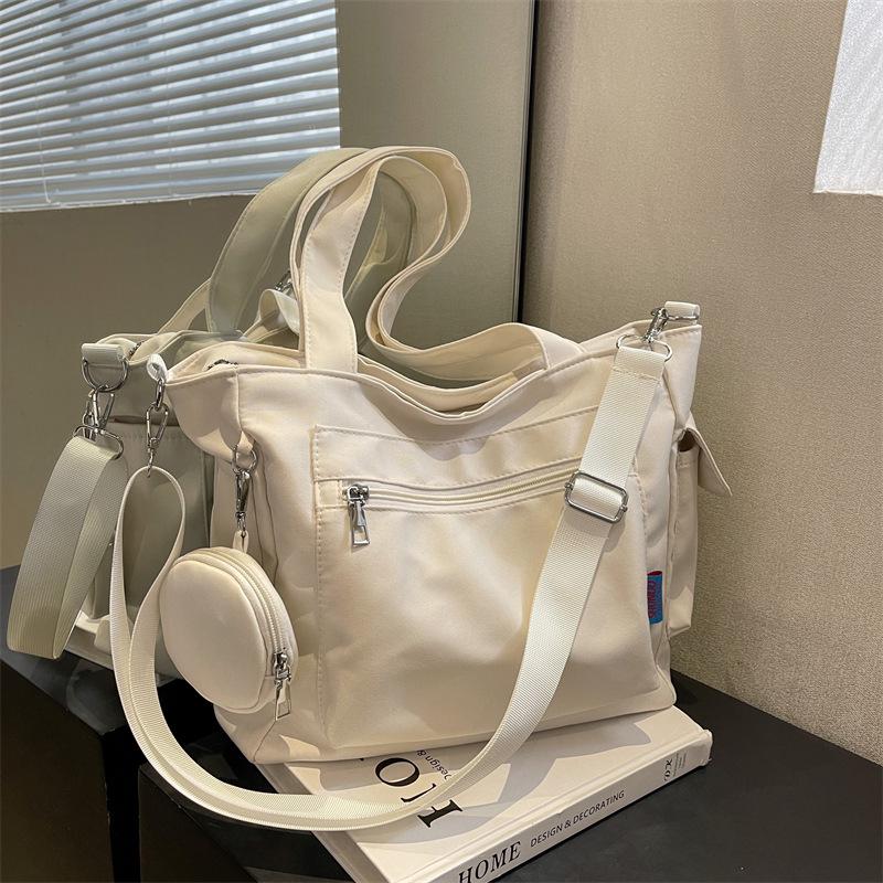 Japanese-Style Canvas Crossbody Bag: Double Pocket, Large Capacity, Women's Tote, Solid Color, Perfect for Students and Commuting.