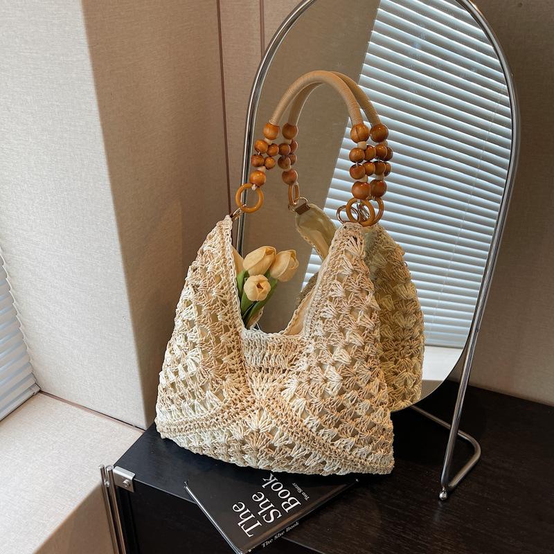 Sommer beliebte gewebte Tasche Damen neue Mode hohl tragbare Umhängetasche Strandurlaub Tragetasche